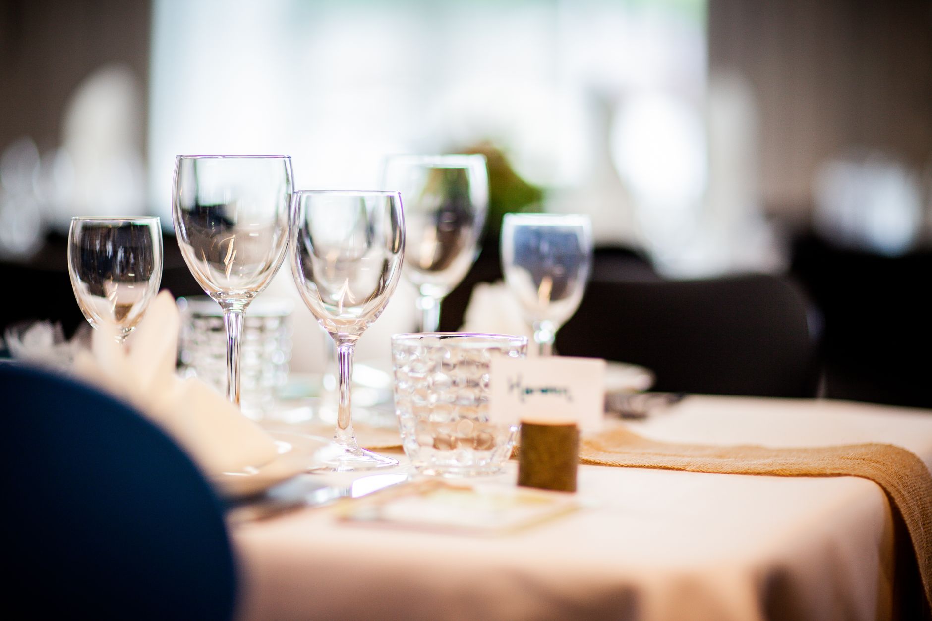 Wine glasses on a set table in soft light