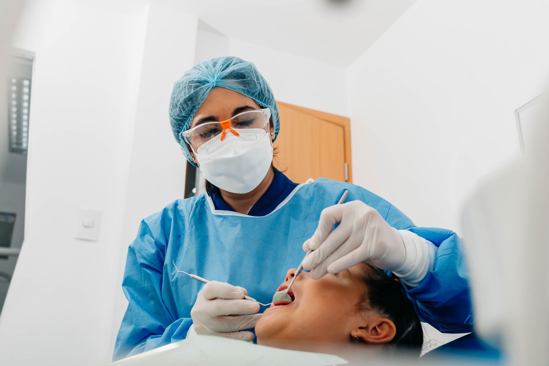 A dentist examining a patient during a check-up in a dental clinic