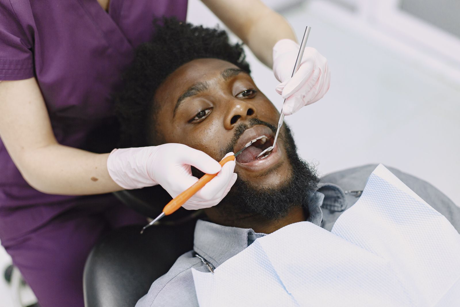A patient in the dental chair having a tooth and gum checked, the kind of visit that finds the source of a gum boil