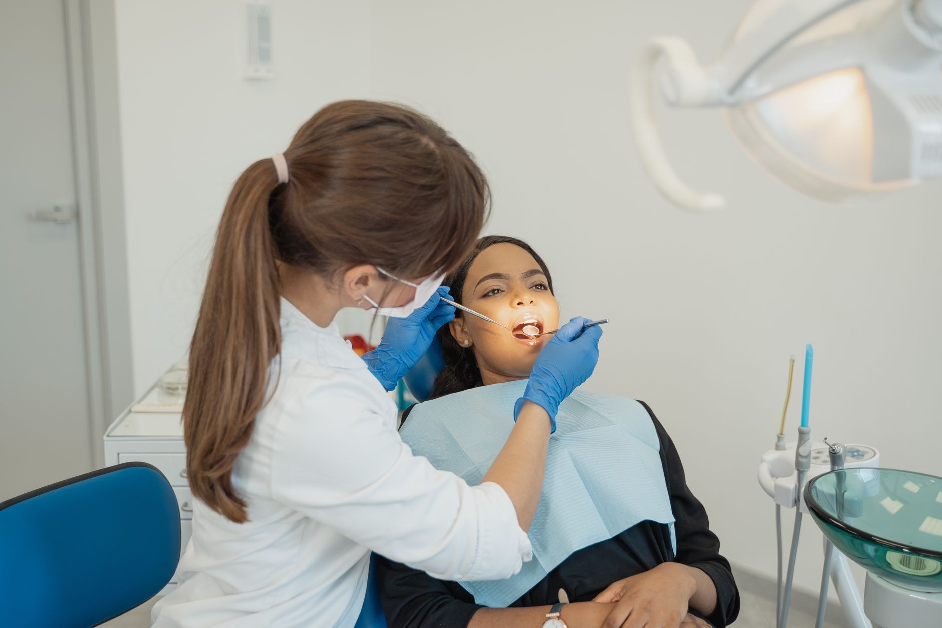 A dentist examining a patient's teeth during a check-up