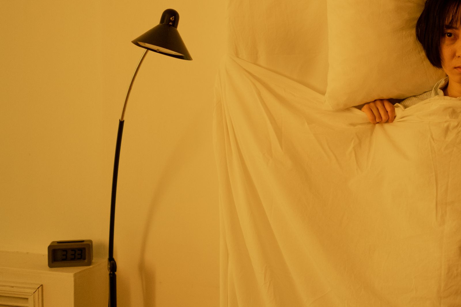 A woman lying awake in bed at night, unable to sleep