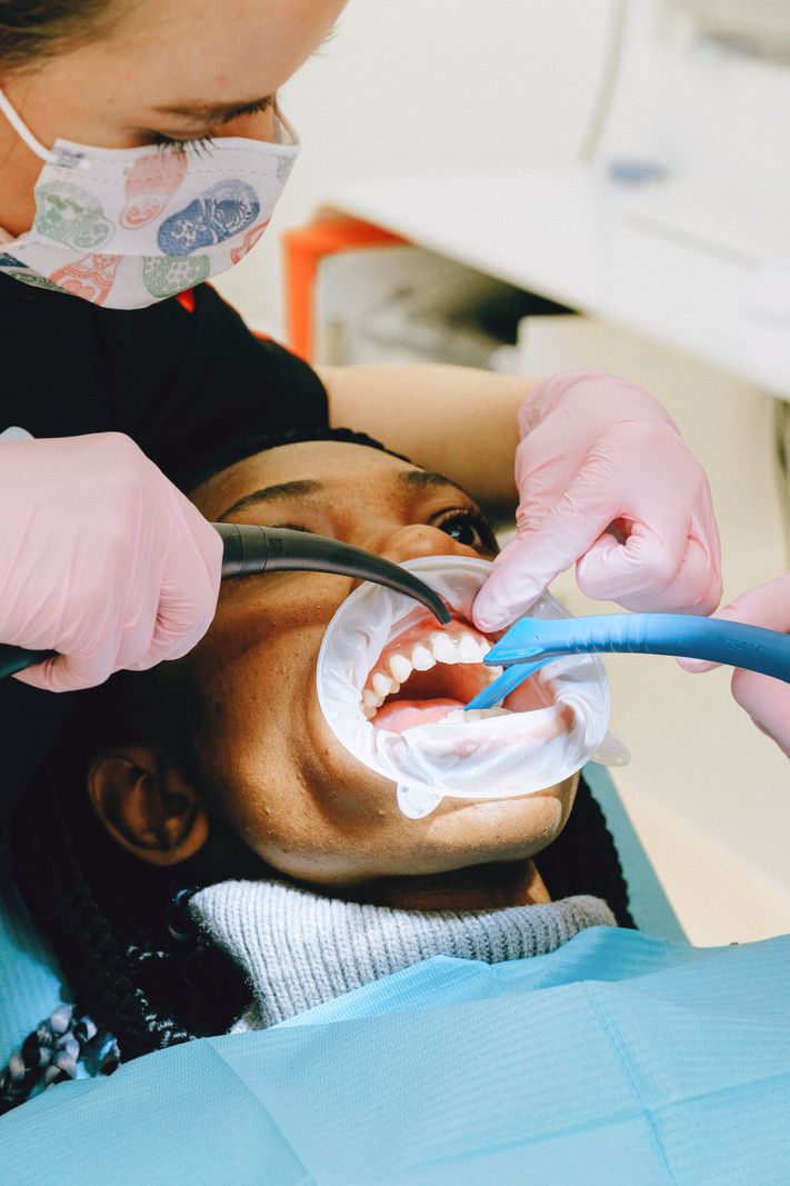 A dentist performing a routine dental checkup and gum exam