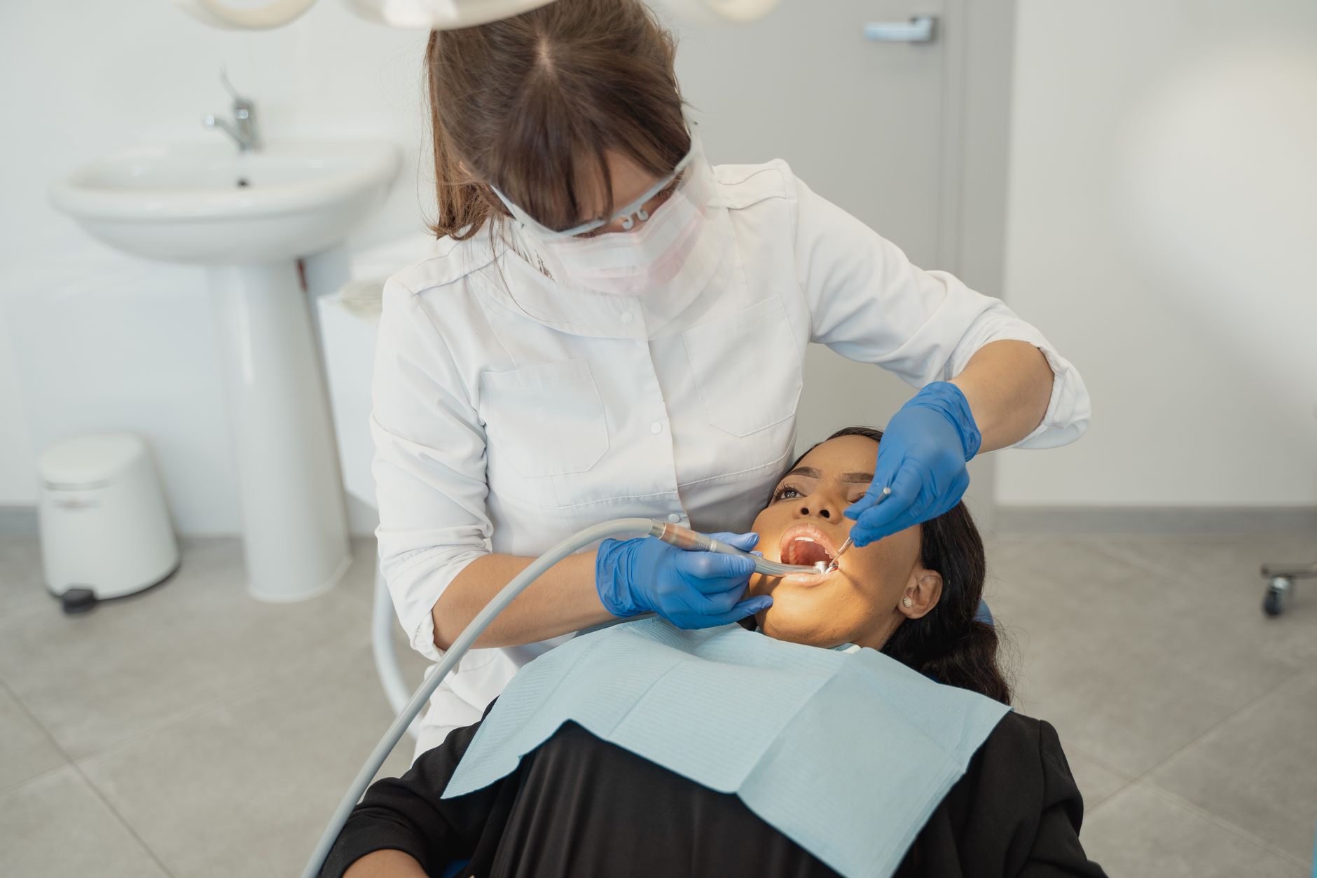 Dentist examining a patient's teeth in a dental clinic