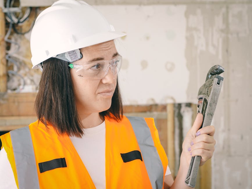 Licensed plumber working under a bathroom fixture