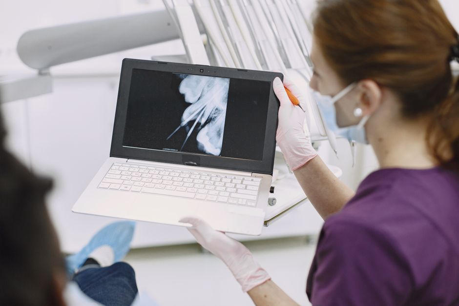 Dentist explaining an X-ray result to a patient