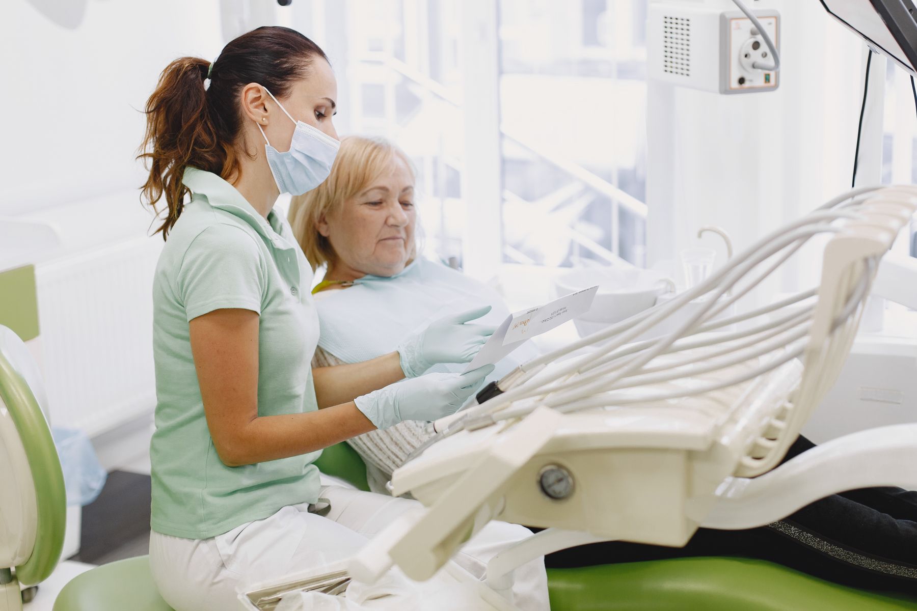 A dentist explaining a diagnosis and treatment plan to a patient