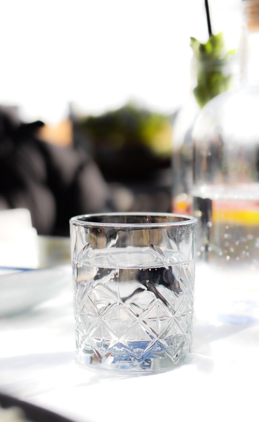 Clear glass of water on a sunlit table
