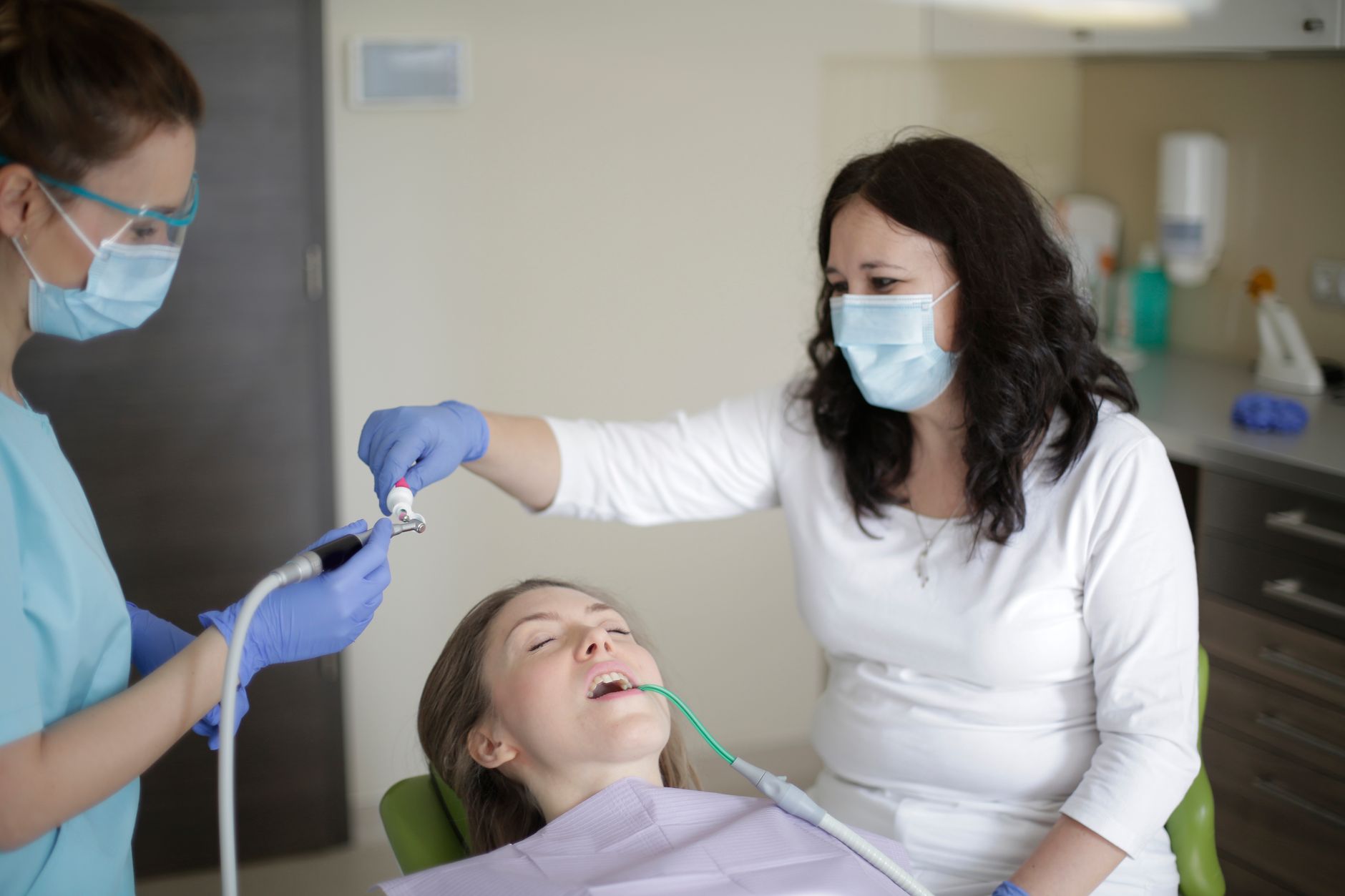 A dentist placing a filling in a patient's tooth