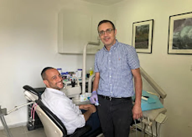 Dr. Gabriel Joel with a patient in the treatment chair at the Beit Shemesh clinic.